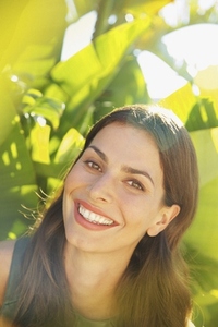 Smiling Woman with Palm Leaves in background