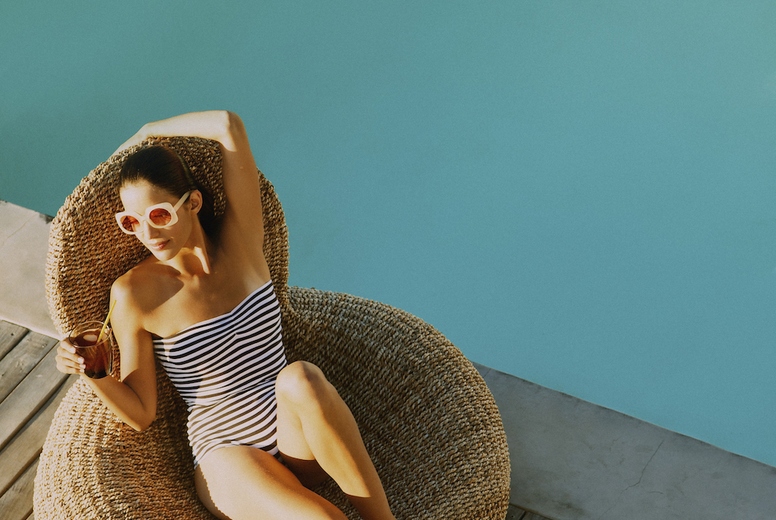 Woman Relaxing by Swimming Pool
