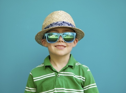 Smiling Boy Wearing Straw Hat and Sunglasses