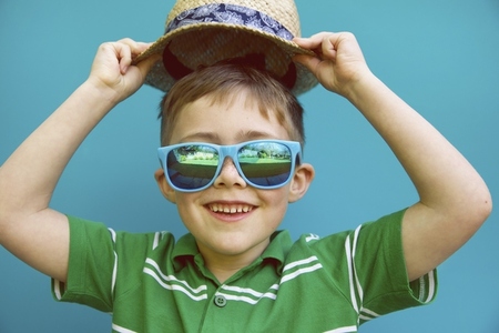 Smiling Boy Wearing Straw Hat and Sunglasses