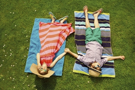 Boy and Girl Sunbathing on Lawn