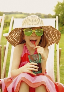 Smiling Girl Wearing Straw Hat and Sunglasses Drinking