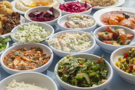 Still life close up variety of Israeli meze appetizers in bowls