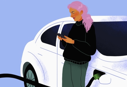 Woman using smart phone waiting for electric car to charge