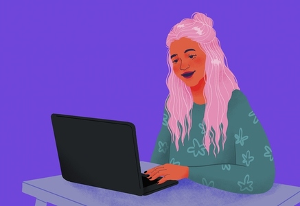 Smiling teenage girl using laptop on purple background