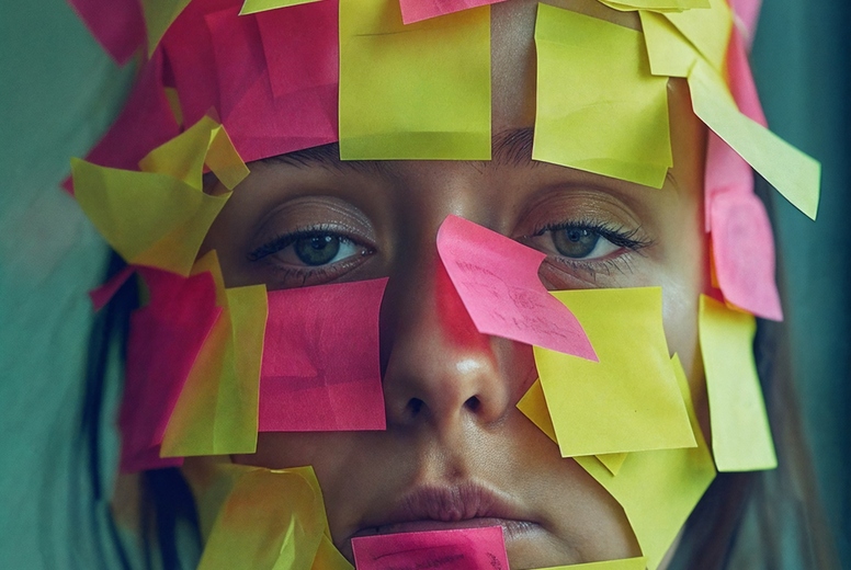 A face covered with post-its.