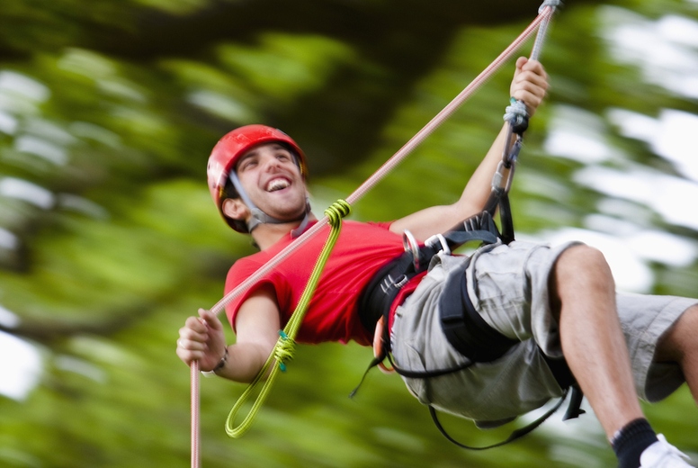 Man dangling from a rope suspended mid air