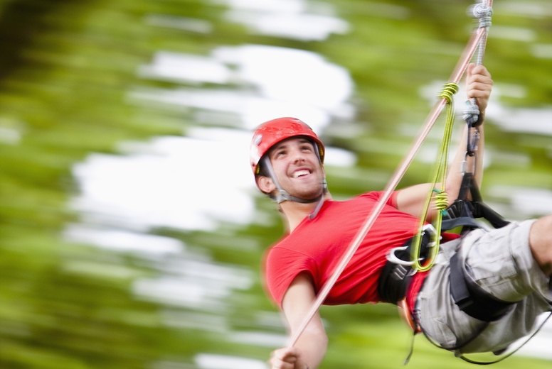 Man dangling from a rope suspended mid air