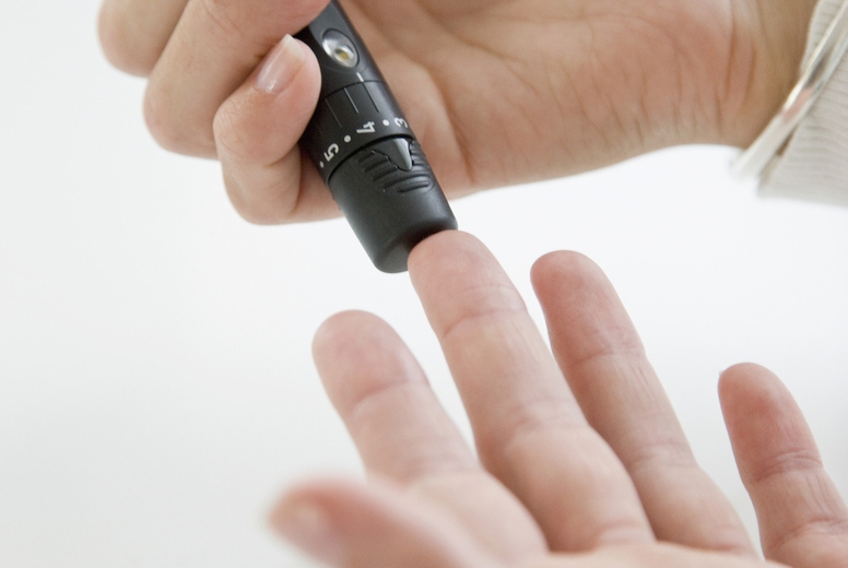 Close up of Woman's Hands Using Glucose Meter
