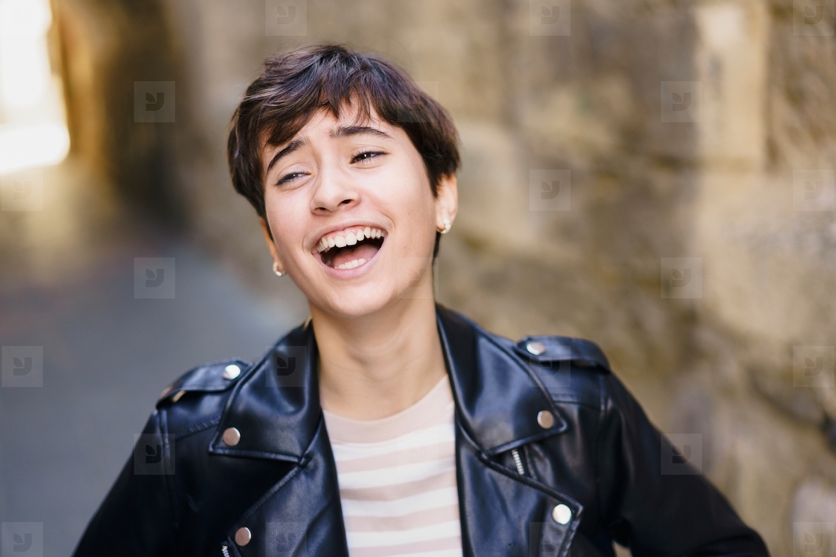 A Joyful Young Woman Laughing Cheerfully in a Lively Urban Setting with Vibrant Colors