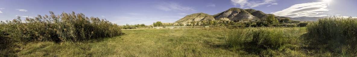 A breathtaking panoramic view of a stunning landscape with rolling hills and vibrant greenery