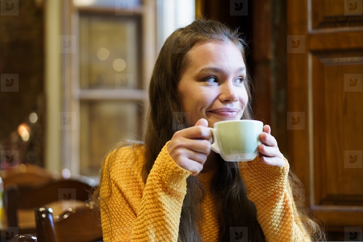 Enjoying a Warm Beverage in a Cozy Caf Setting