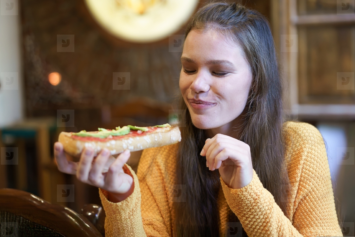 Delightfully savoring a freshly made sandwich while relaxing in a cozy and warm setting