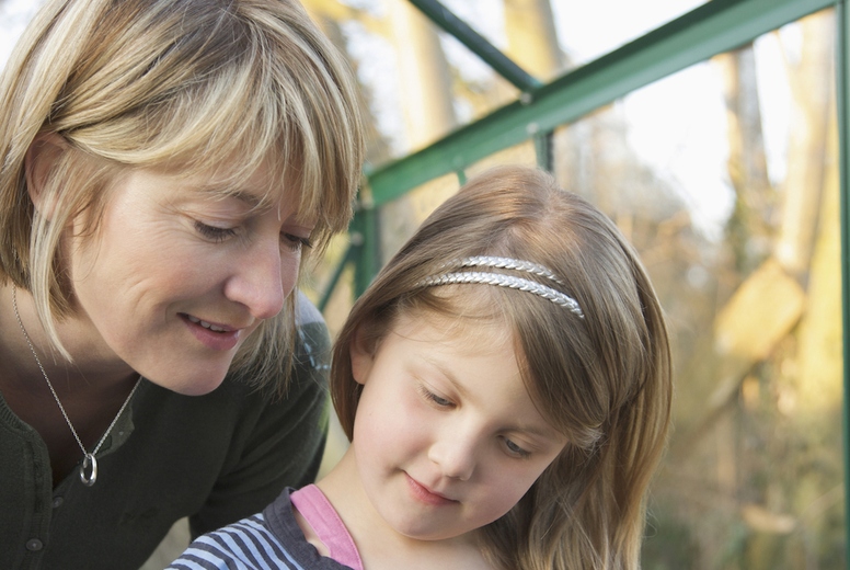 Close up of mother and daughter planting seeds