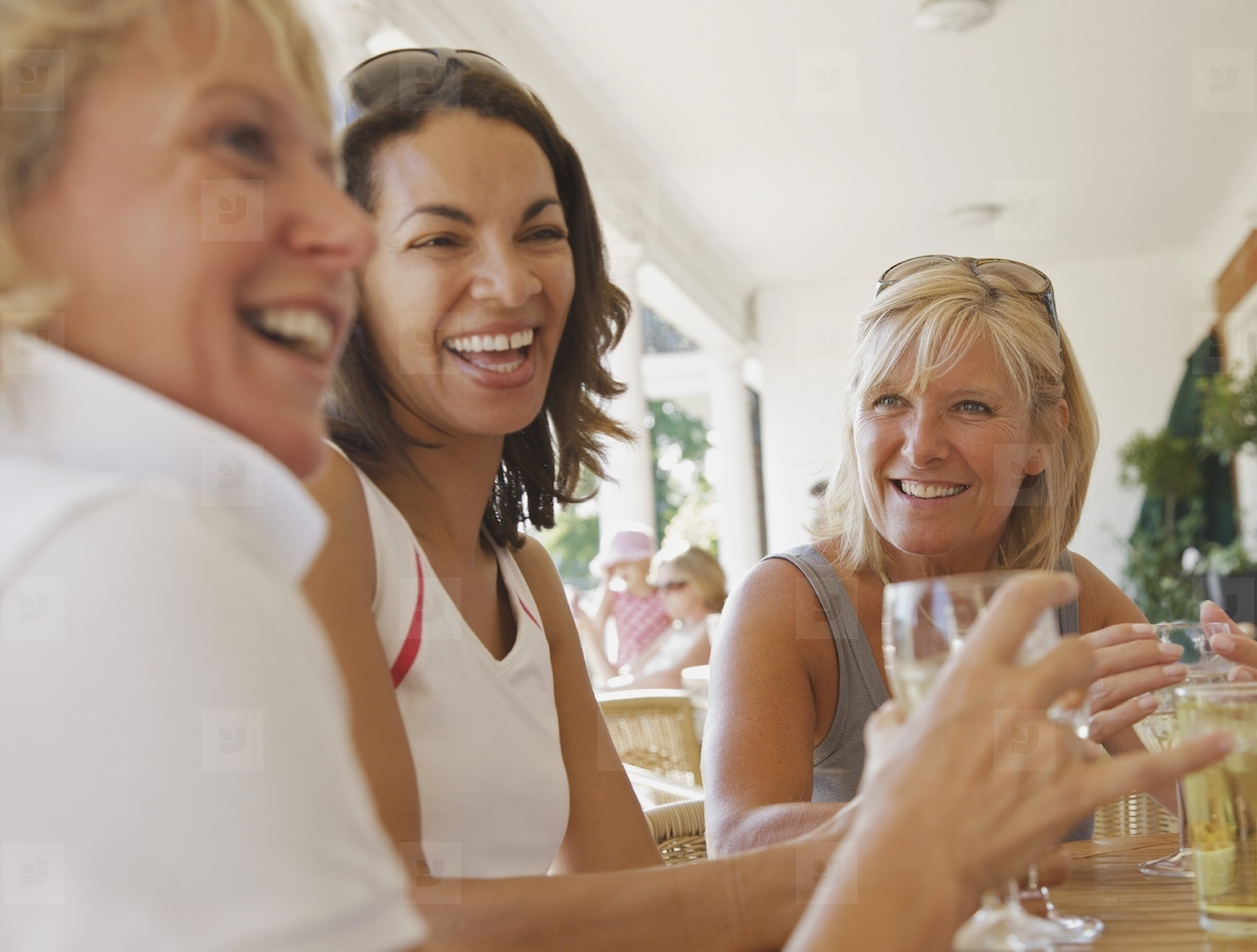 Women drinking and laughing at a restaurant