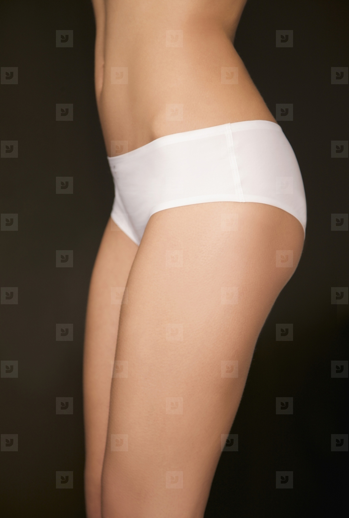 Profile of a womans body wearing white underwear