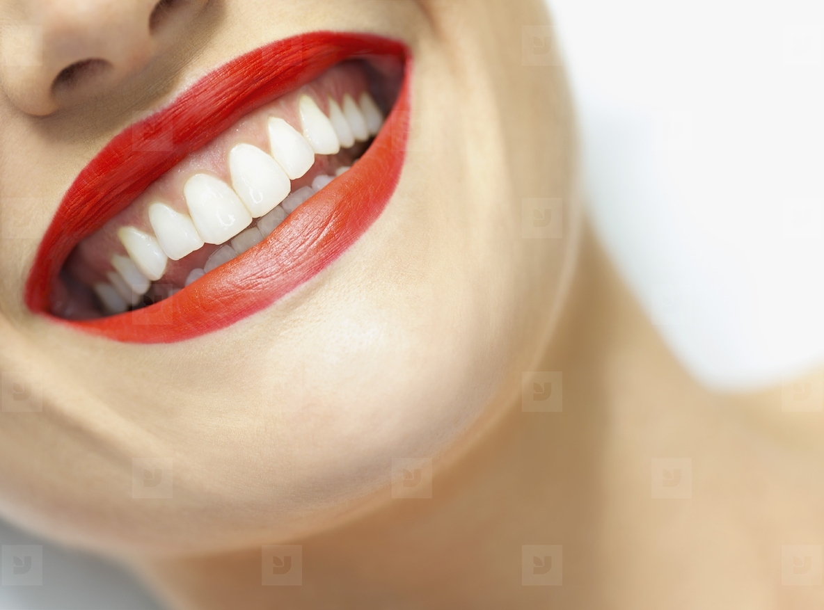 Close up of Womans Smiling Mouth with Red Lipstick