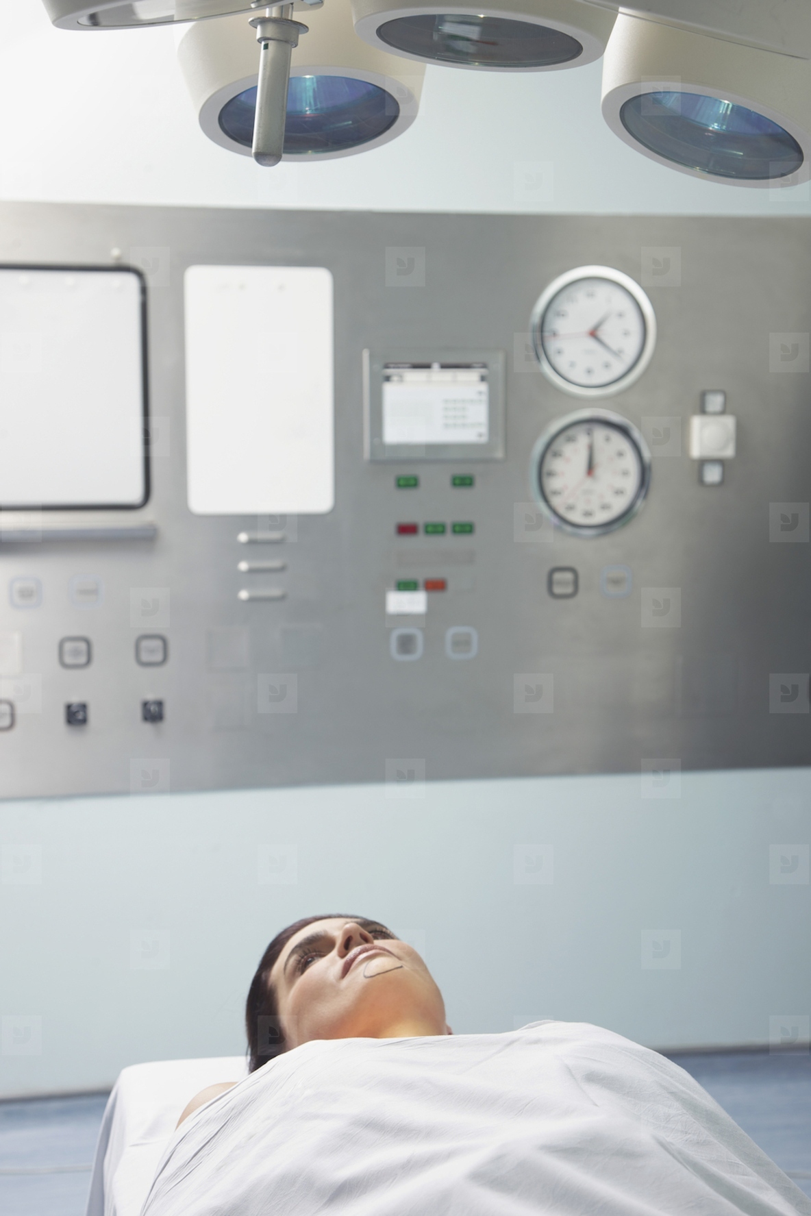 Woman Lying on Operating table under Examination light
