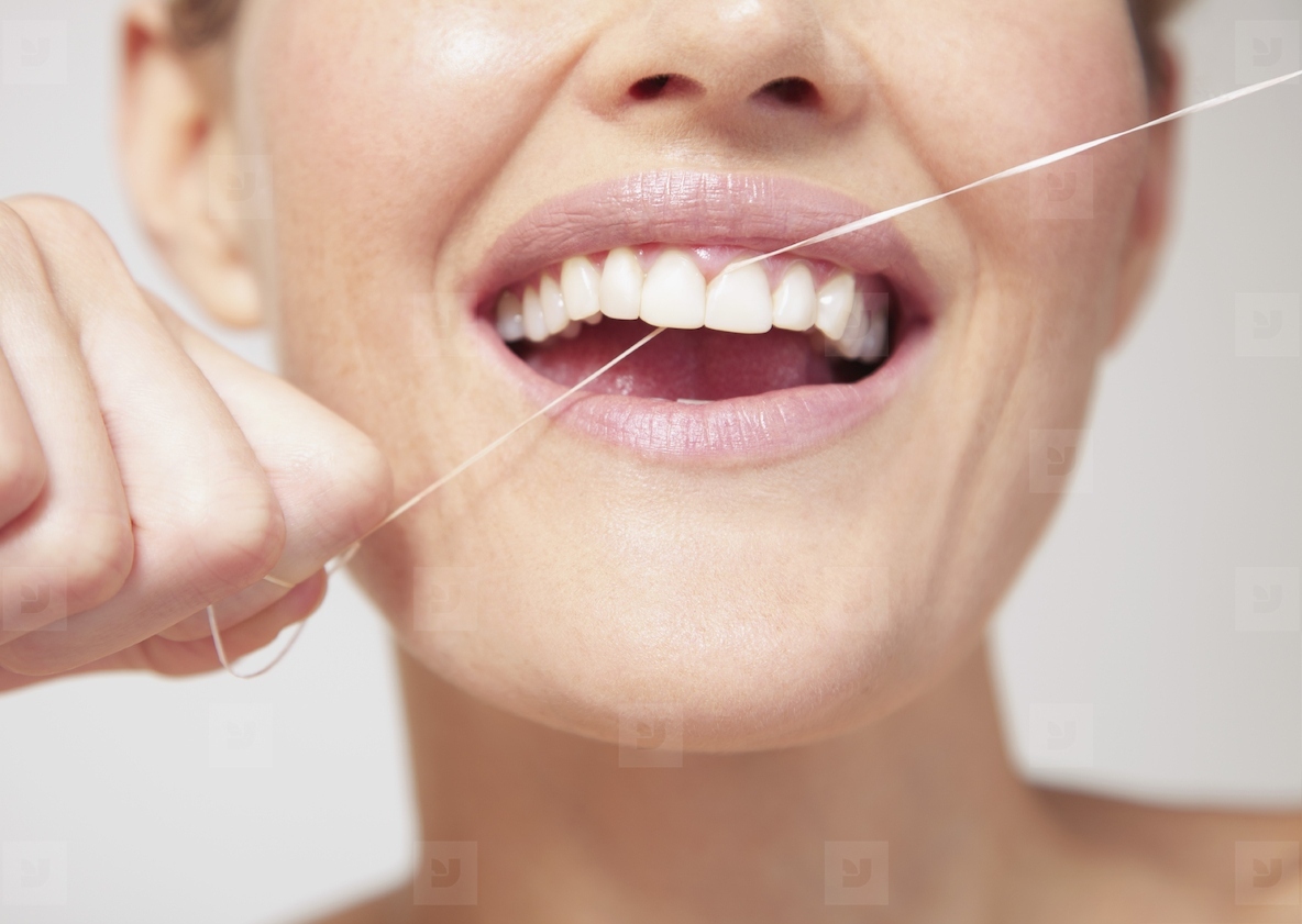 Woman Flossing Teeth Close up view