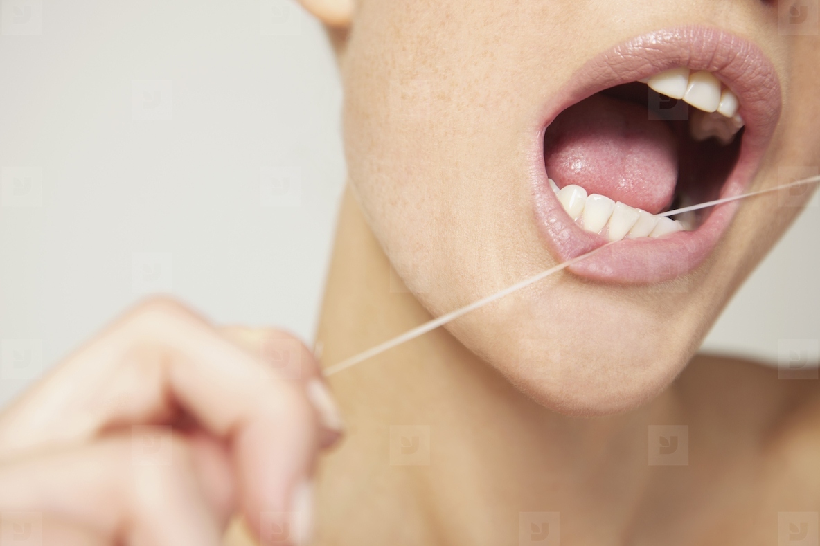 Woman Flossing Teeth Close up view