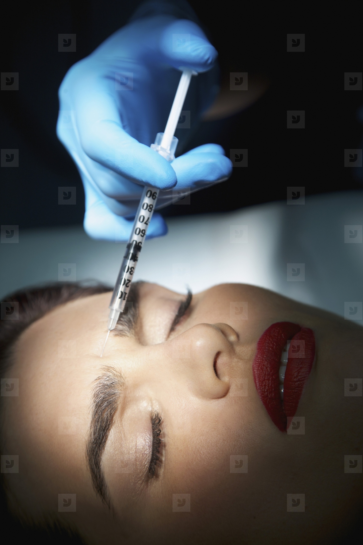 Woman Receiving Botox Injection on Forehead Close up view