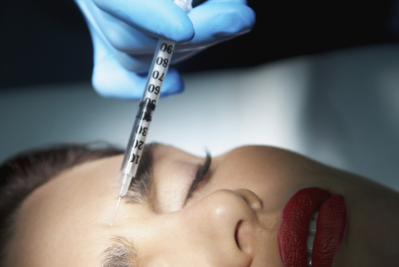 Woman Receiving Botox Injection on Forehead - Close-up view