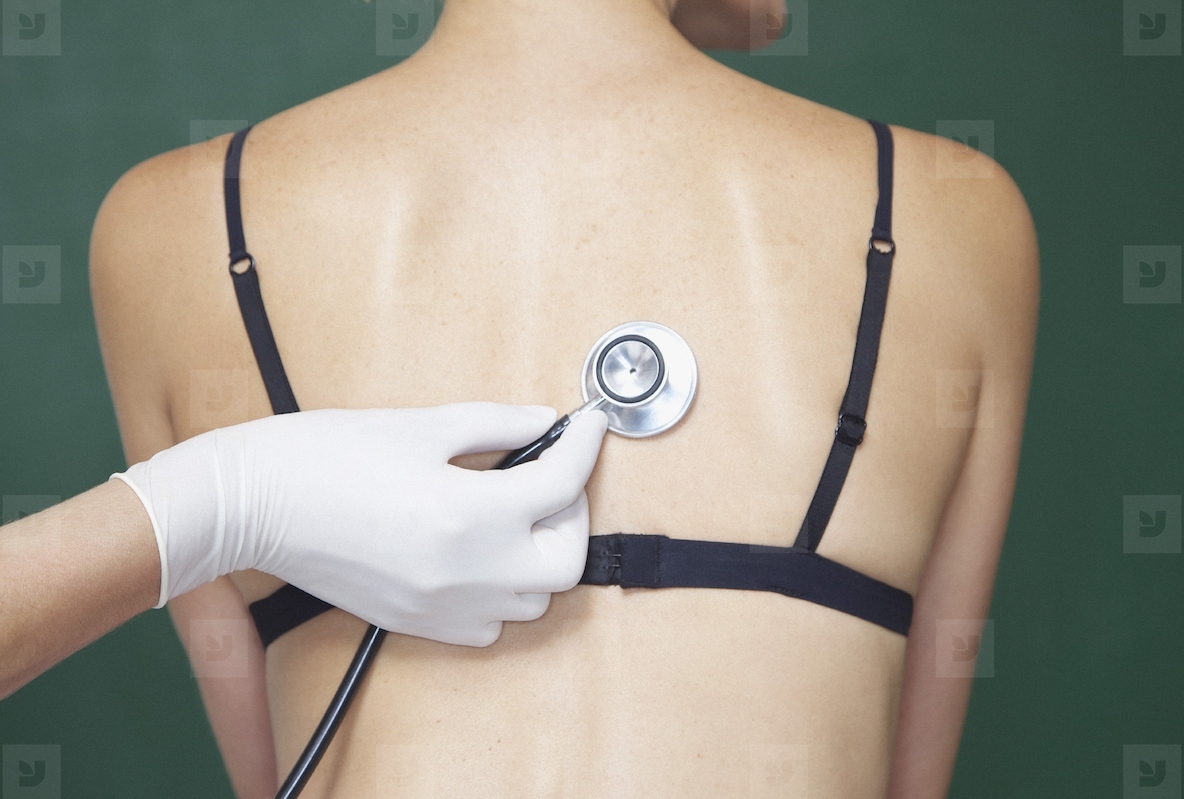 Doctors Hand Holding Stethoscope to Womans Back