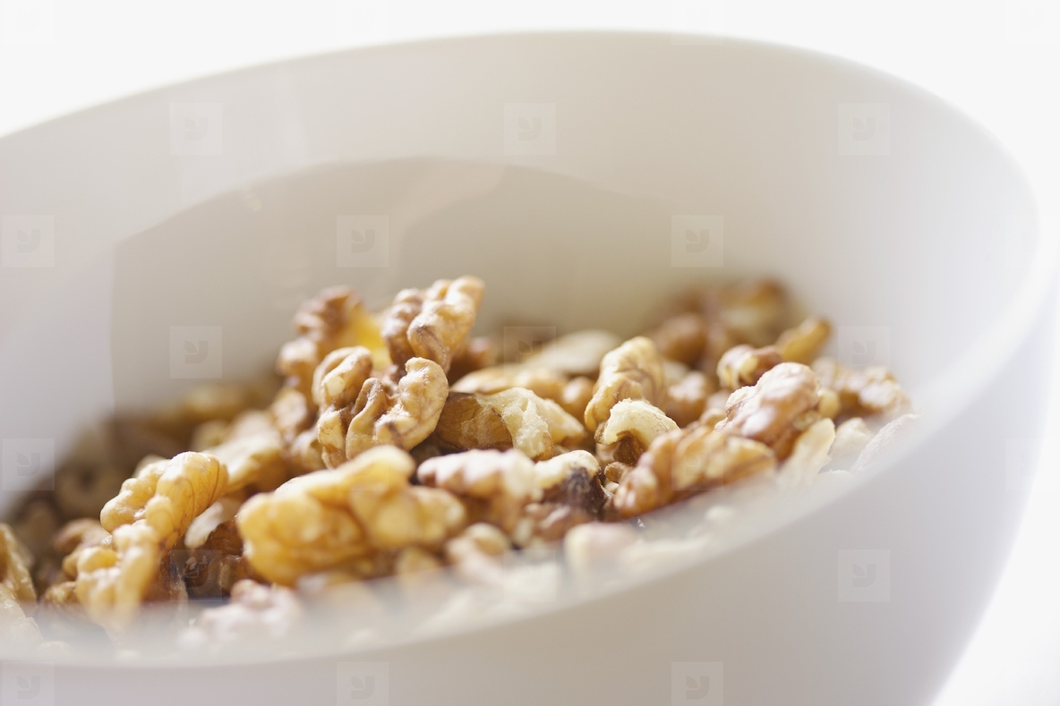 White Bowl Filled with Walnuts Close up view