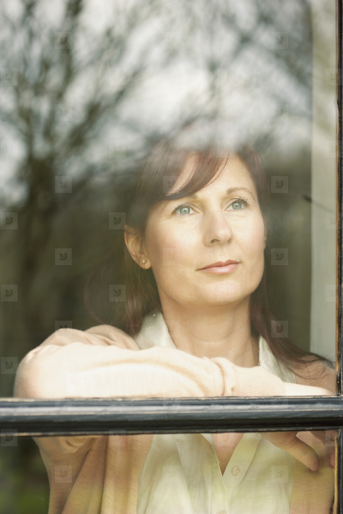 Woman Standing behind Window
