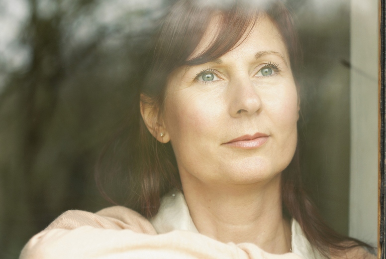 Woman Standing behind Window