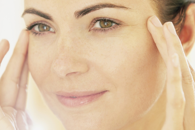 Smiling Woman with Hands on Face