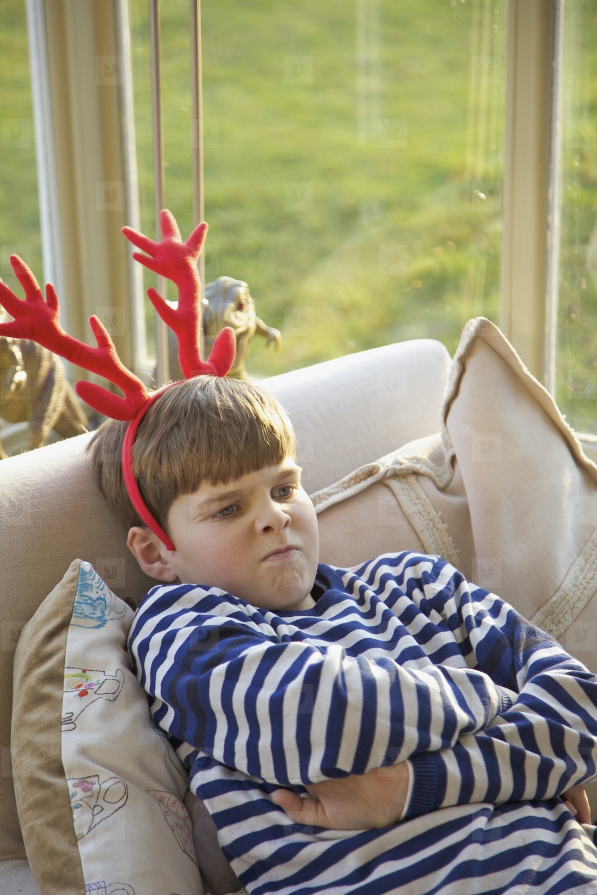 Boy Wearing Christmas Antlers Pulling Faces