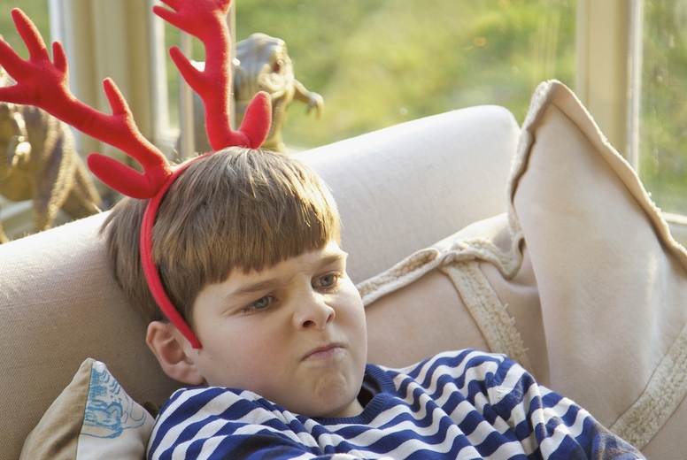 Boy Wearing Christmas Antlers Pulling Faces