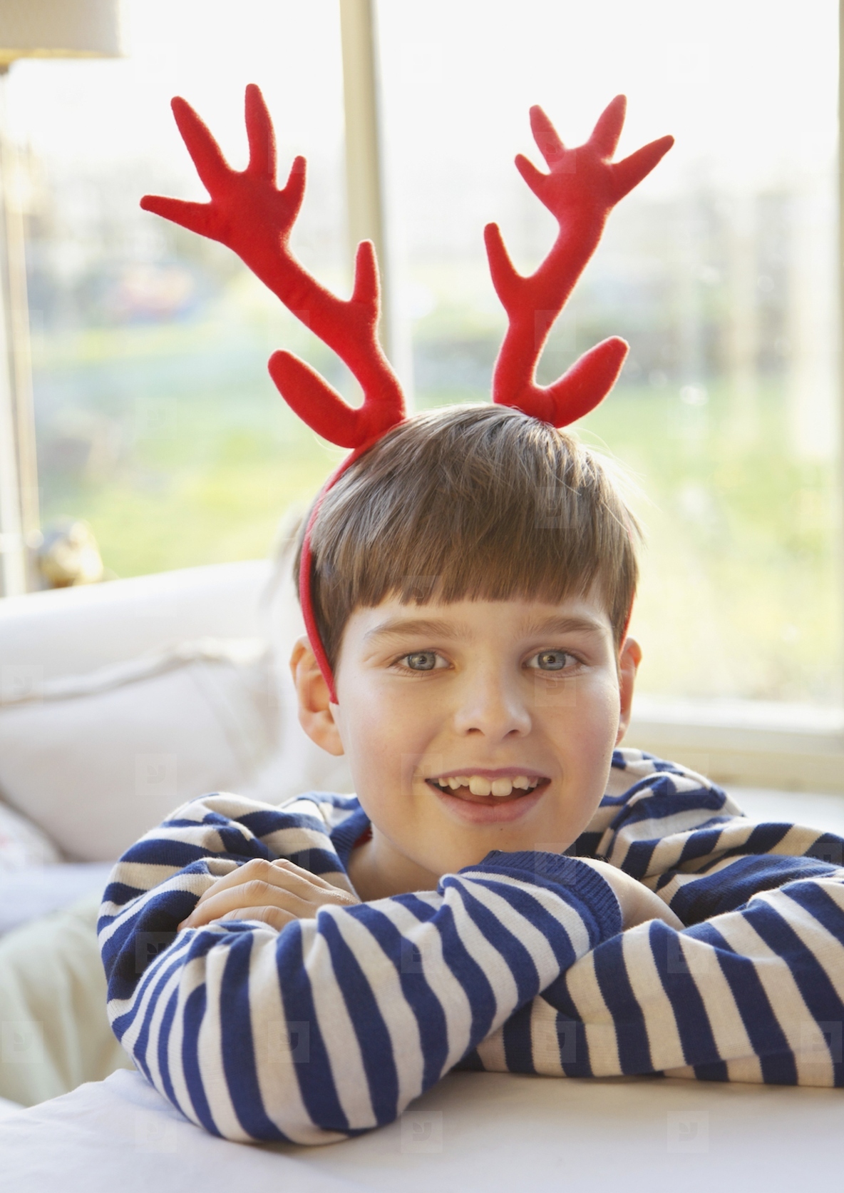 Smiling Boy Wearing Christmas Antlers