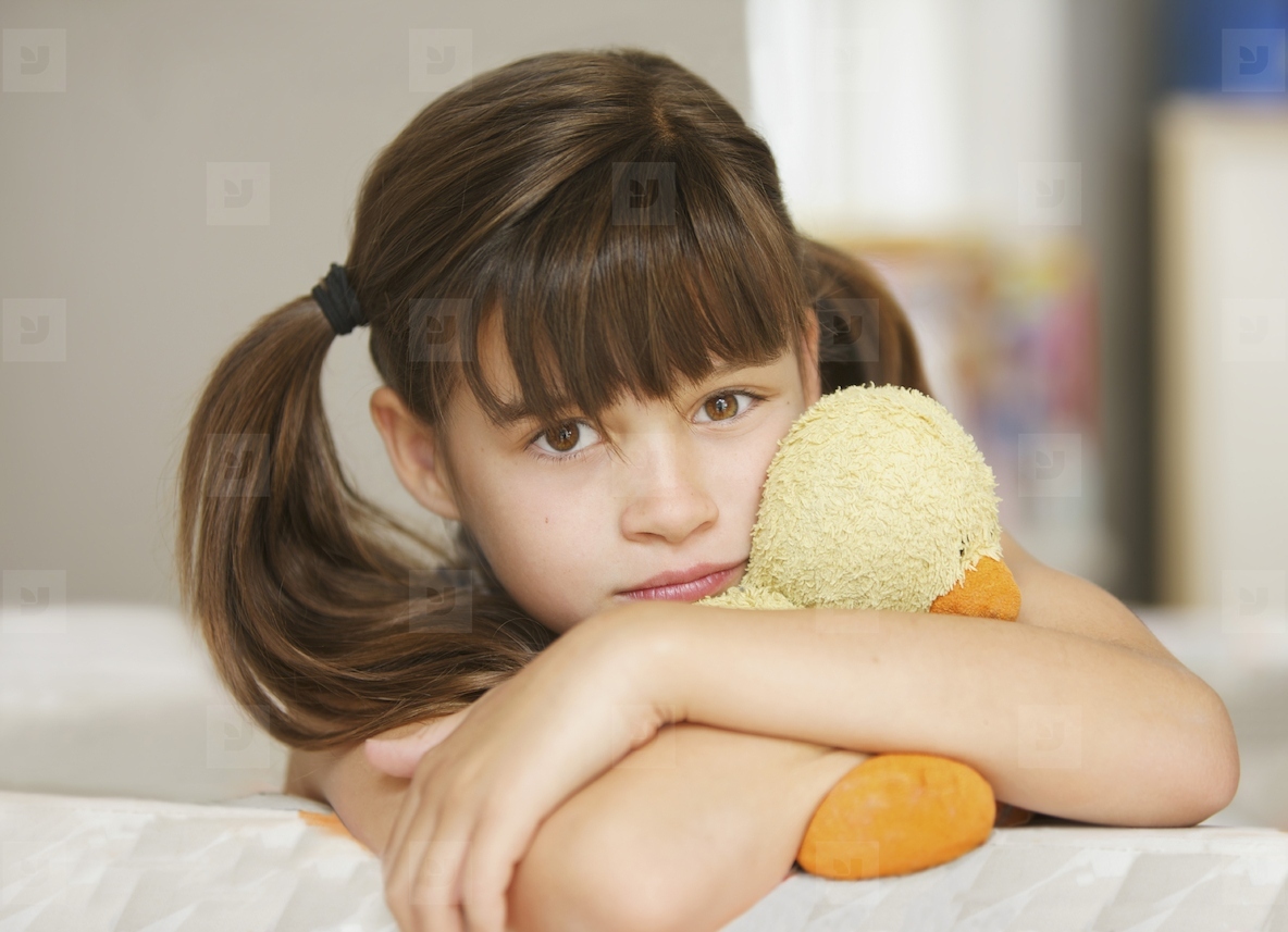 Girl Hugging a Stuffed Toy Duck