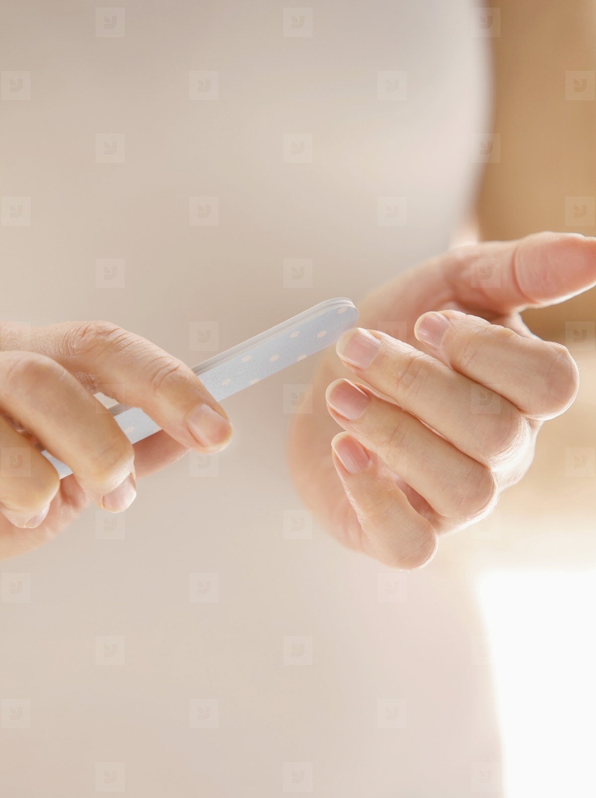 Woman Filing Fingernails