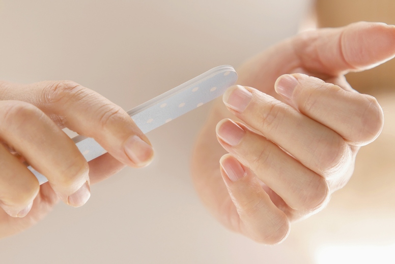 Woman Filing Fingernails