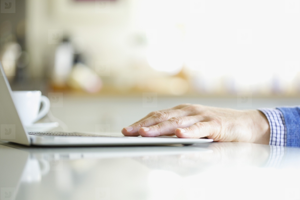 Close up of Mans Hand Using Laptop