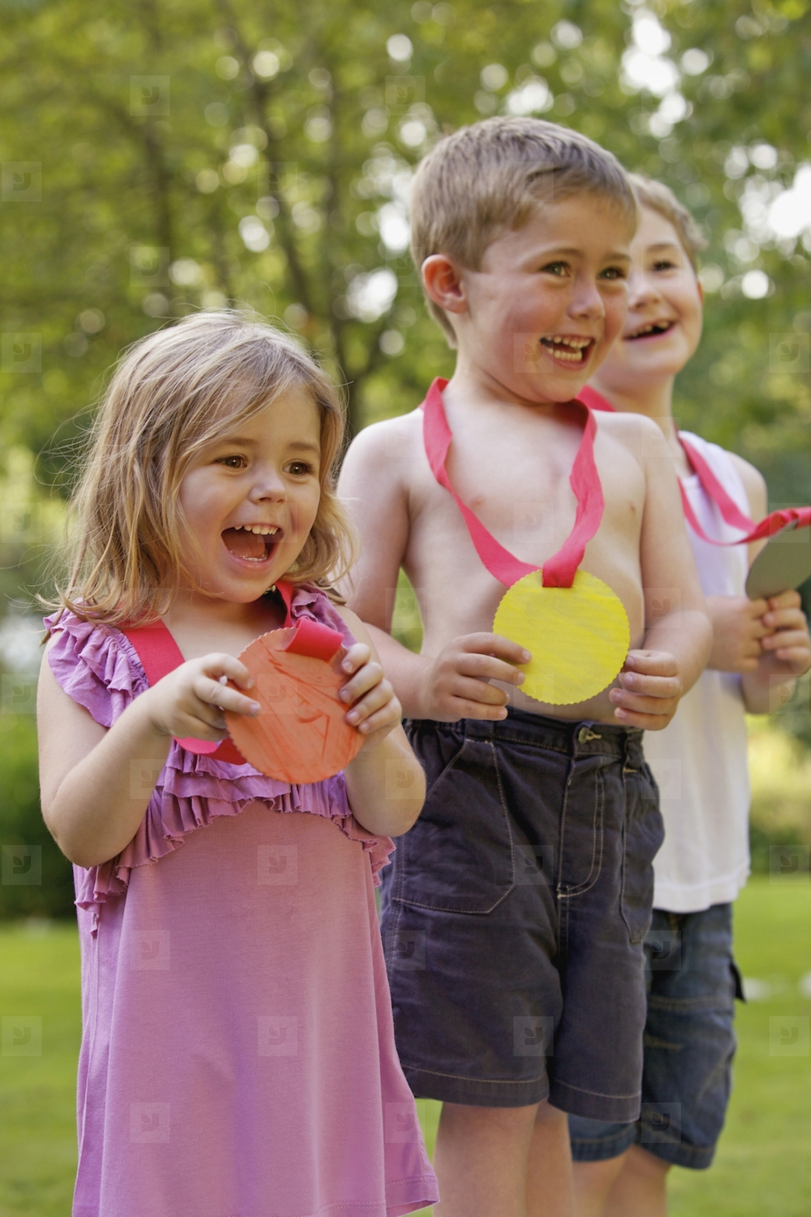 Smiling Children Holding Cardboard Medals