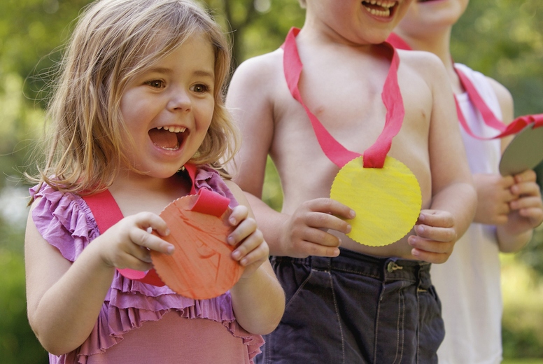 Smiling Children Holding Cardboard Medals