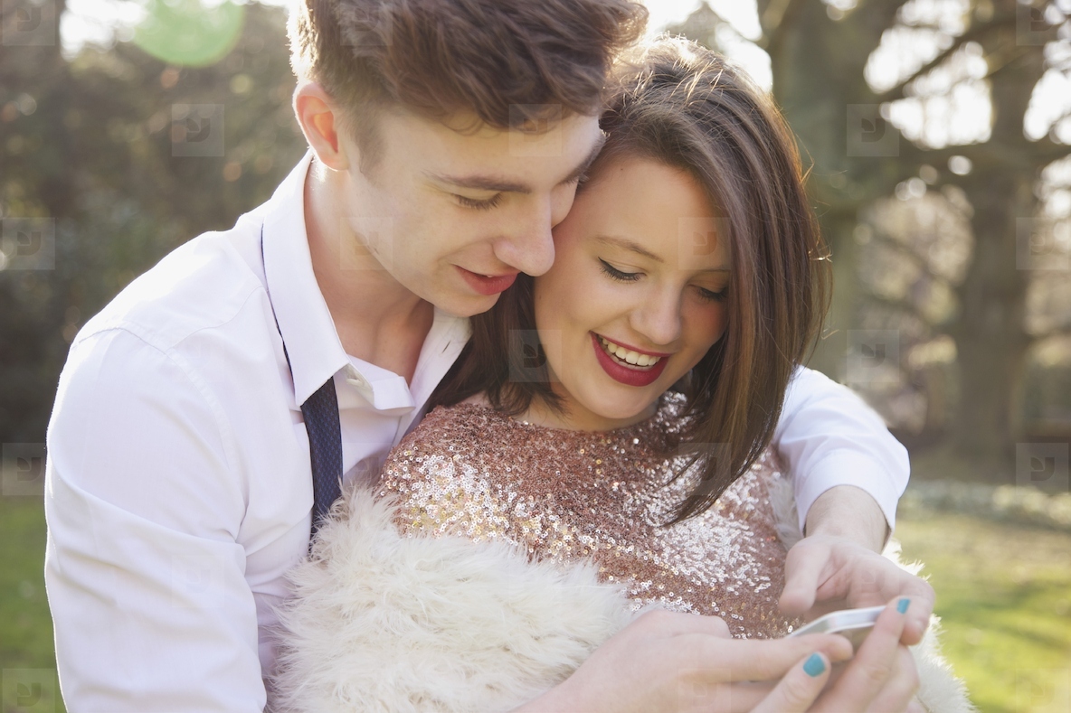 Young Couple Using Cell Phone