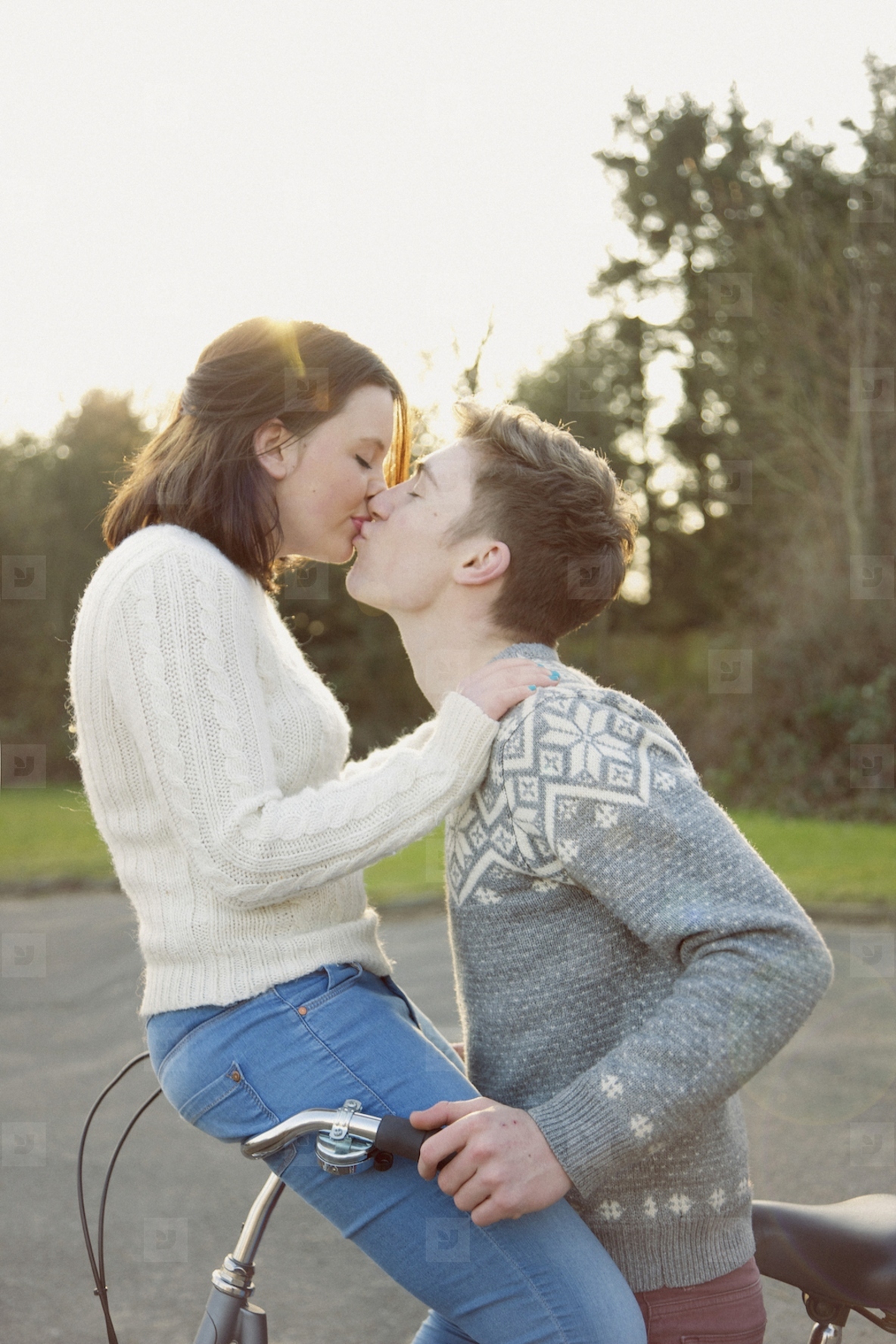 Young Couple Kissing on Bicycle