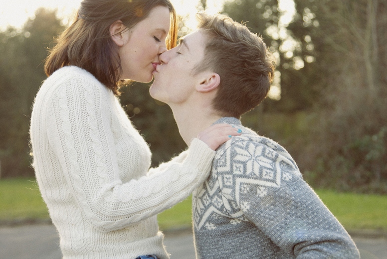 Young Couple Kissing on Bicycle