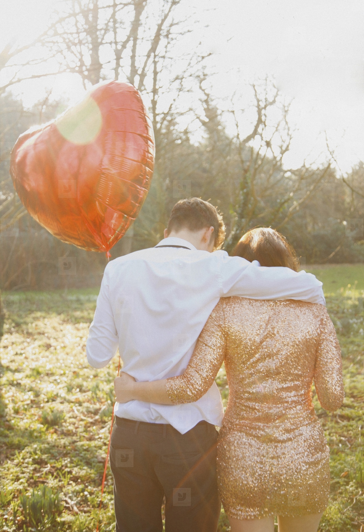Couple in Park Holding Heart Shaped Balloon  Back View