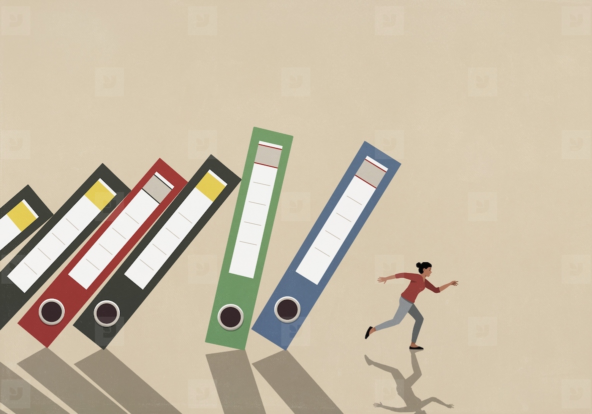 Businesswoman running from falling binders