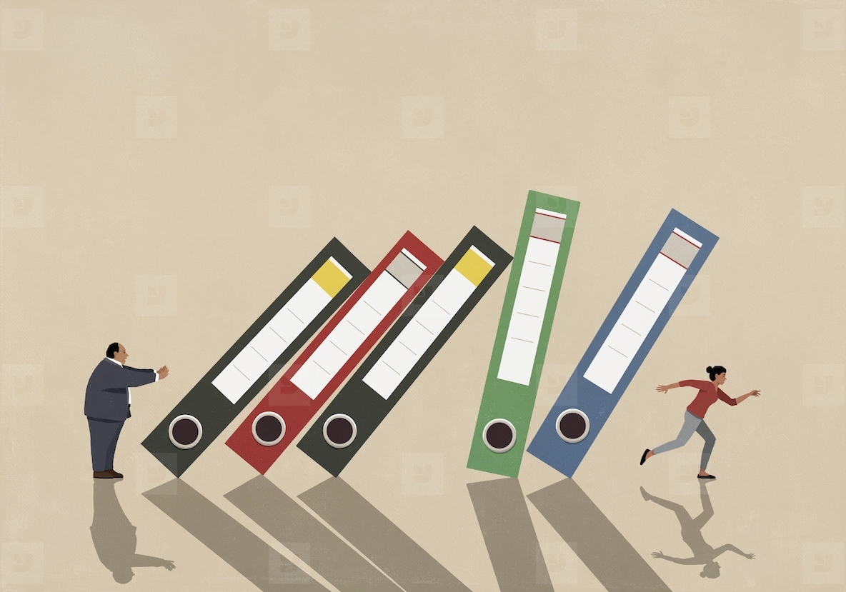 Boss pushing large binders falling over running businesswoman