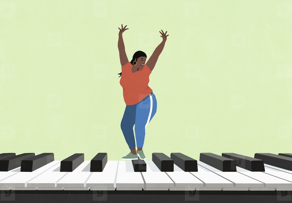 Happy  carefree young woman dancing on large piano on green background