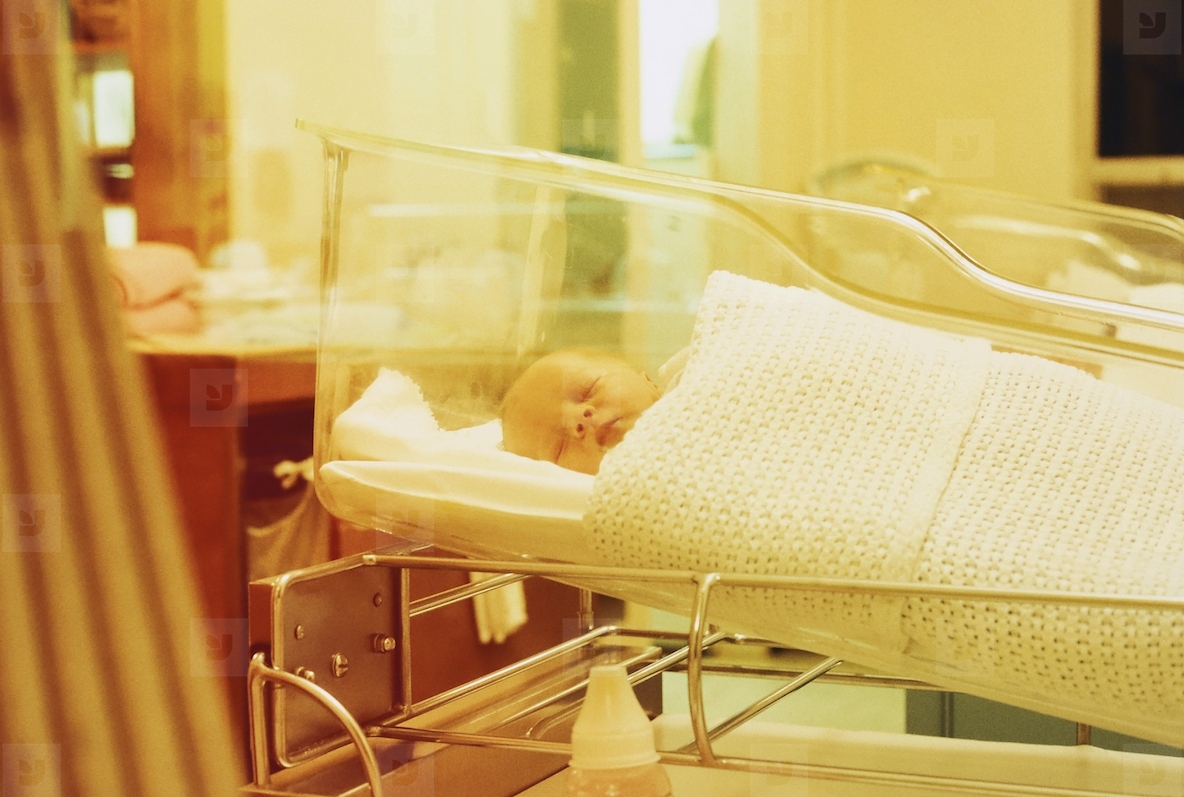 Newborn boy sleeping in hospital maternity ward