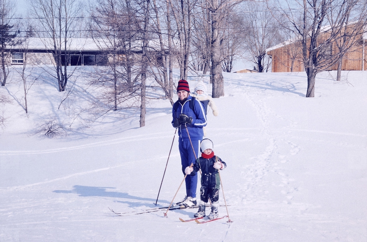 Portrait father and children cross country skiing in snow