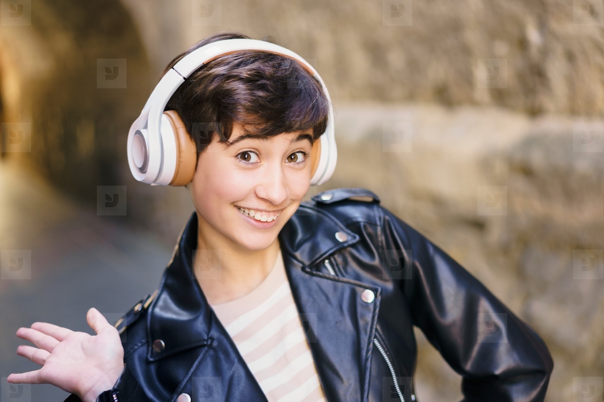 A Stylish Young girl Wearing Headphones Captured in an Urban Setting Full of Life